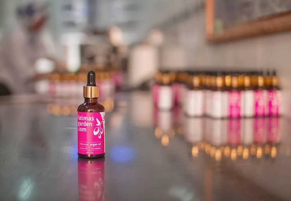 A row of argan oil bottles on the production line in Agadir